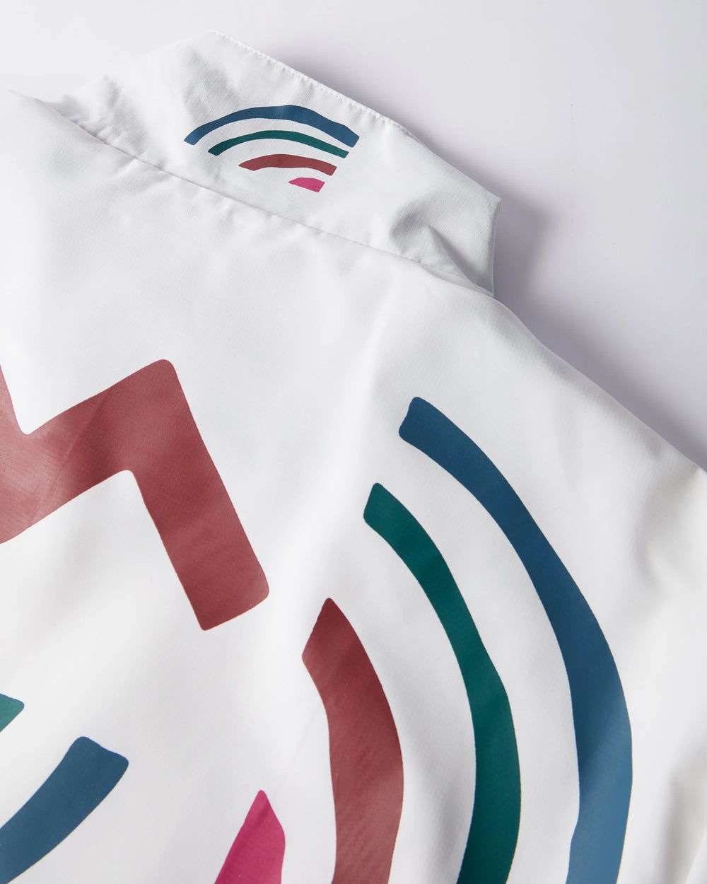 Close-up detail of the printed collar on the white byParra Tennis Maybe? Track Jacket.