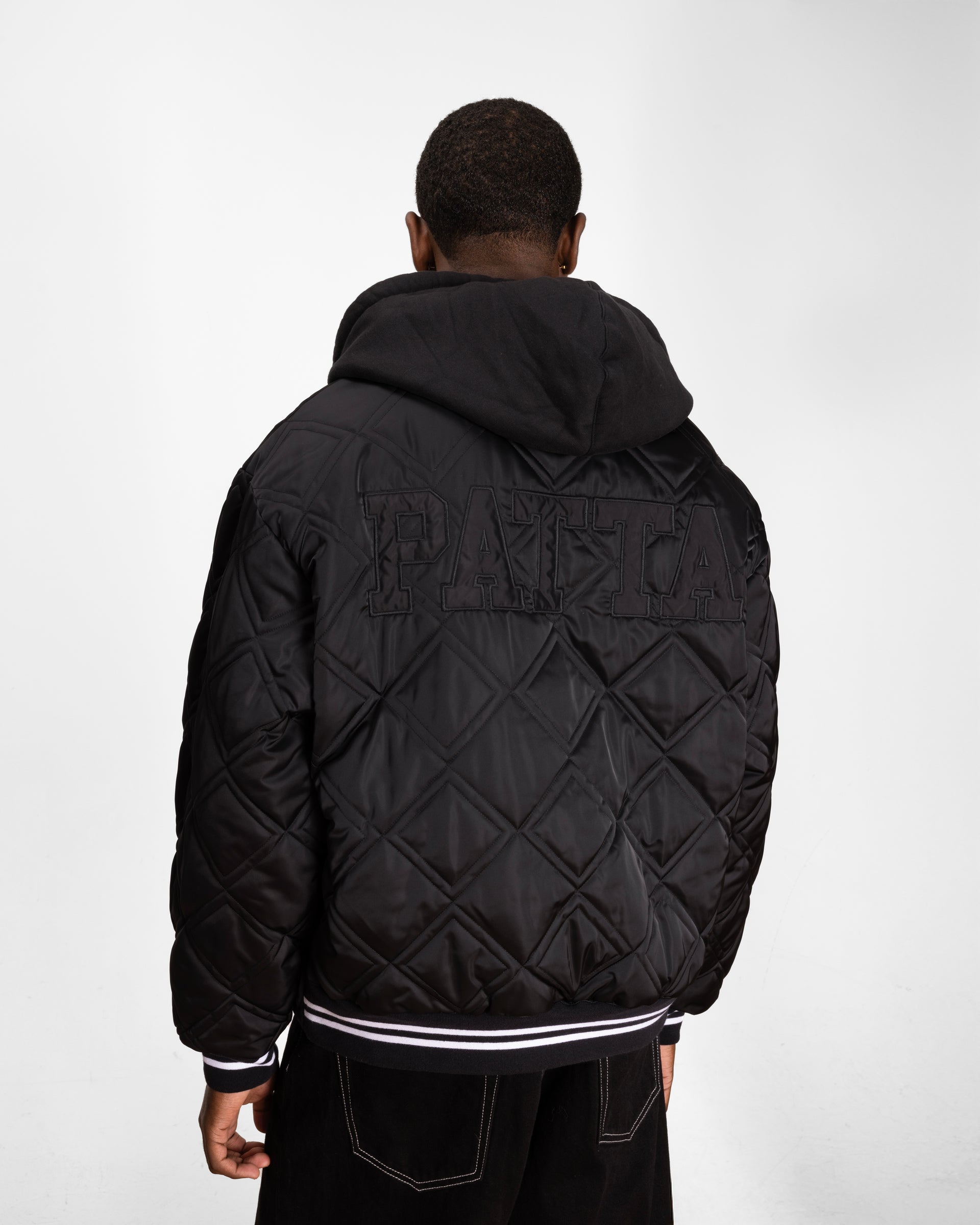 close up model shot showing the back side of the model and showcasing the quitled paneling and embossed patta branding.