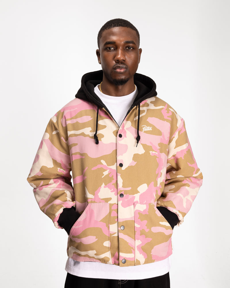 close up model shot of the camo side of the reversible woodland camo bomber